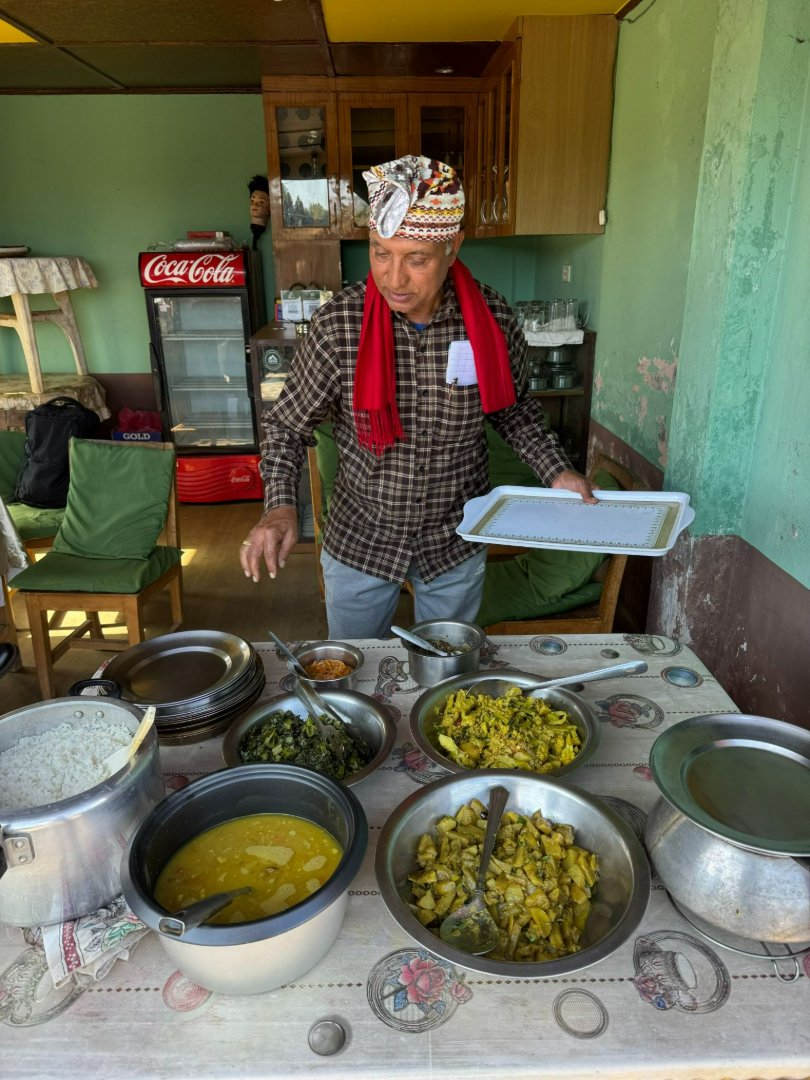 Old man helping her wife in kitchen at Balthali Homestays