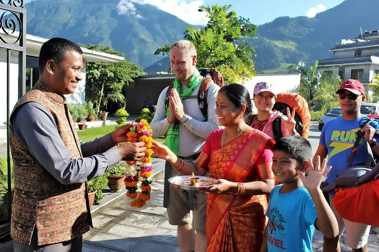 Hosts welcoming guest in Homestay