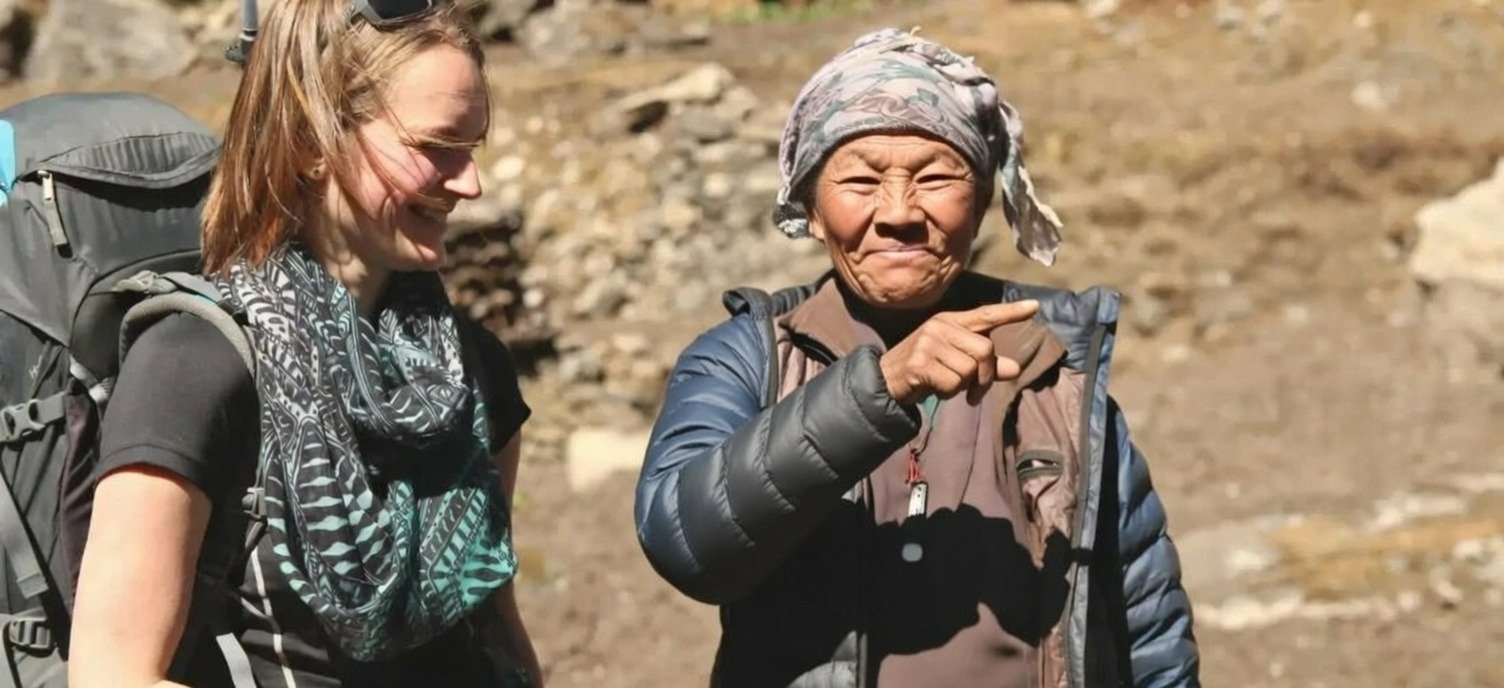 old nepali women with a tourist