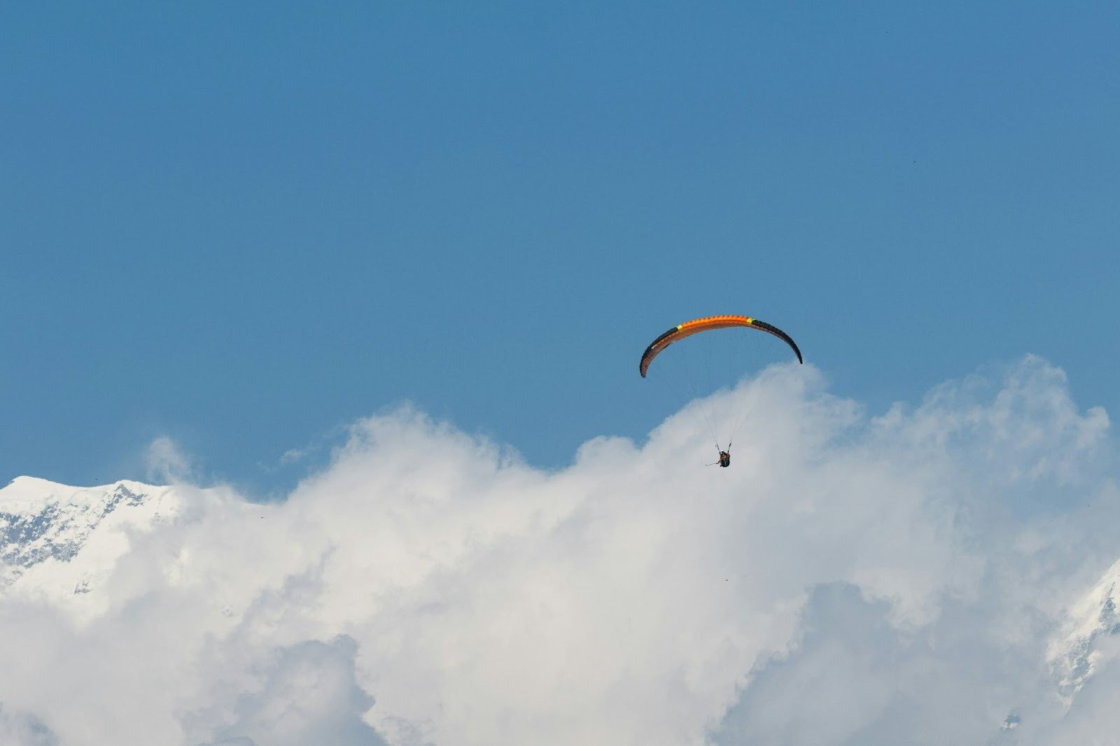 Paragliders flying above clouds over Pokhara, Nepal