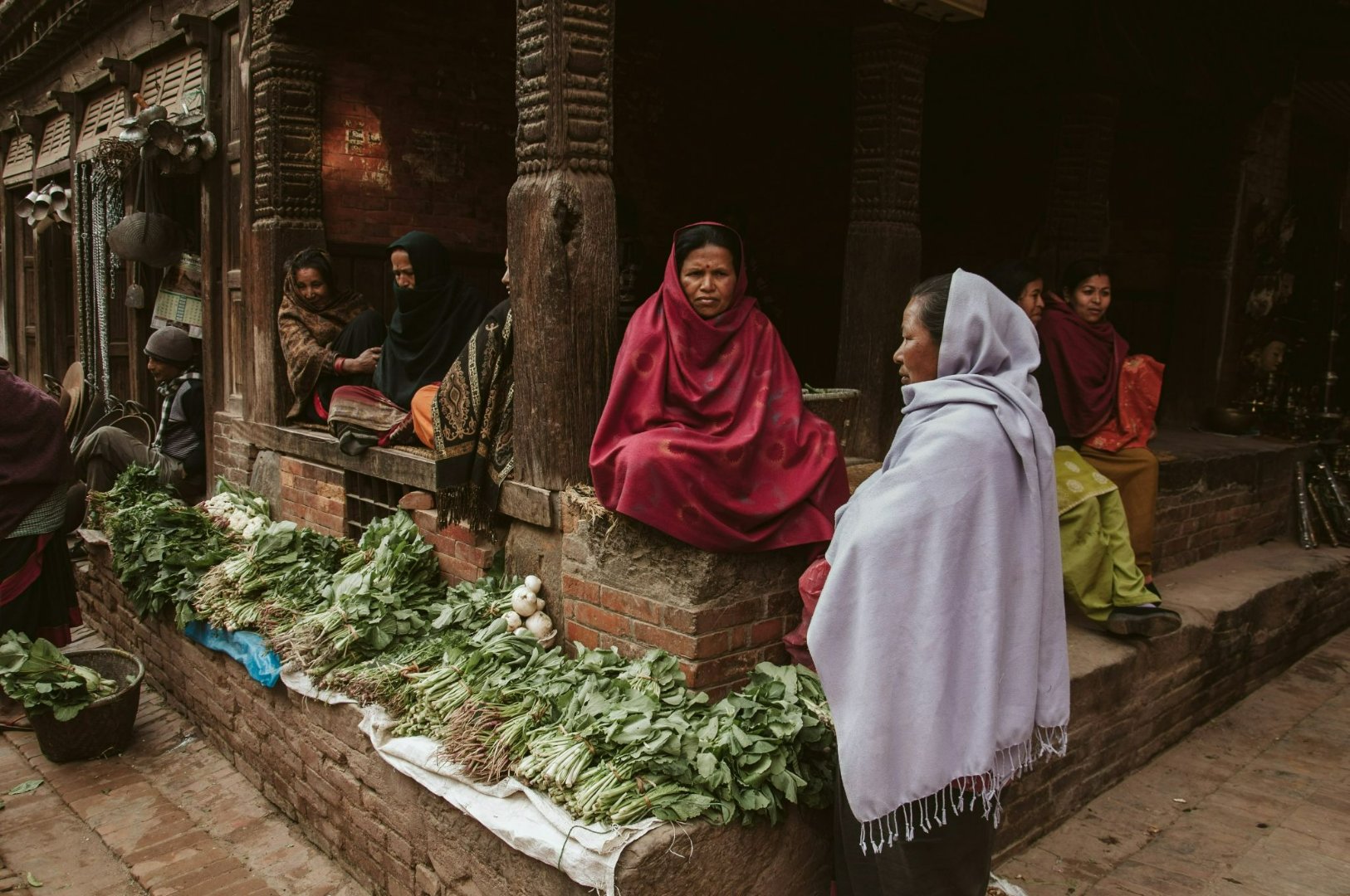Women at a traditional vegetable market.