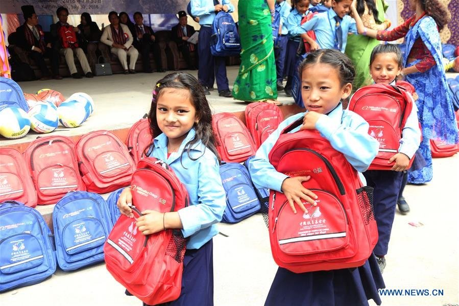 rural nepal kids with bag in hand